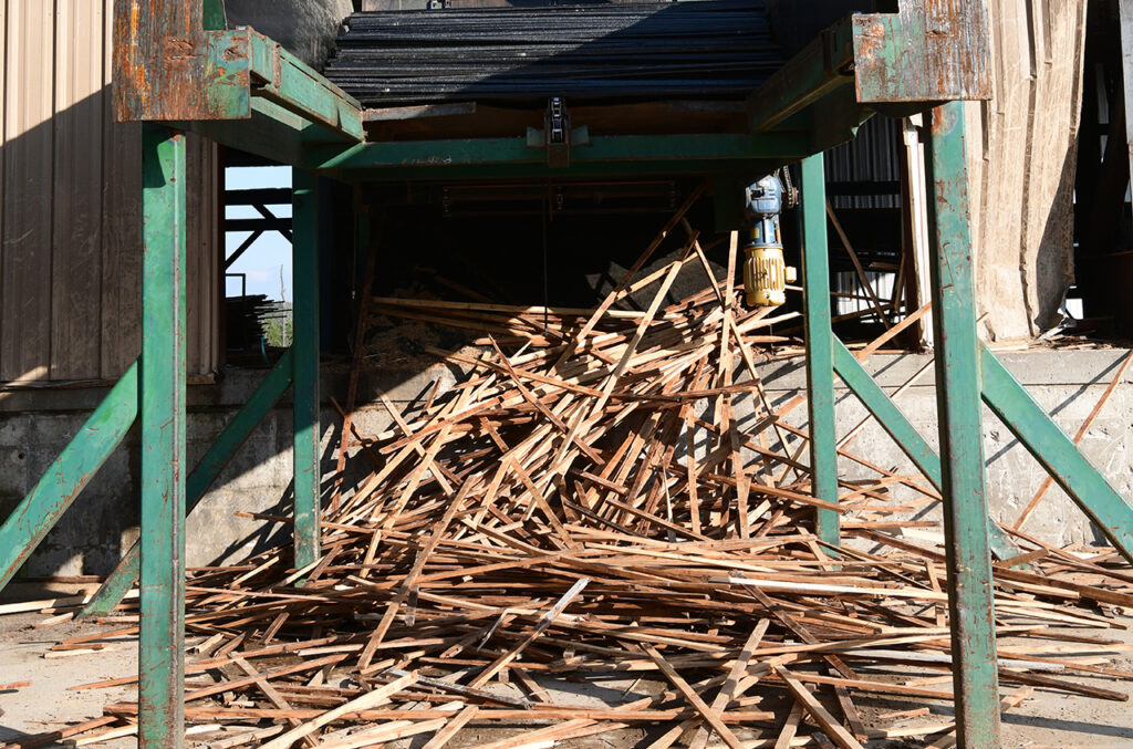 Pile of regular kiln sticks under loader.